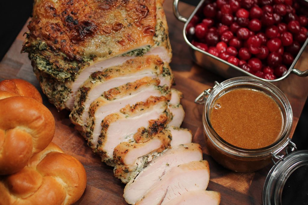 Sliced roasted turkey breast with challah rolls and fresh cranberries by Catering by Michaels