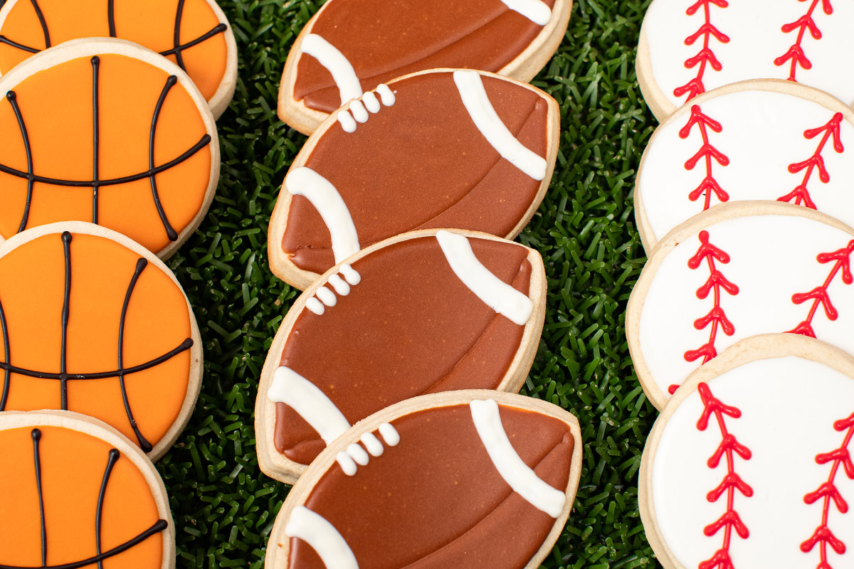 Decorate cookies of footballs, baseballs and basketballs