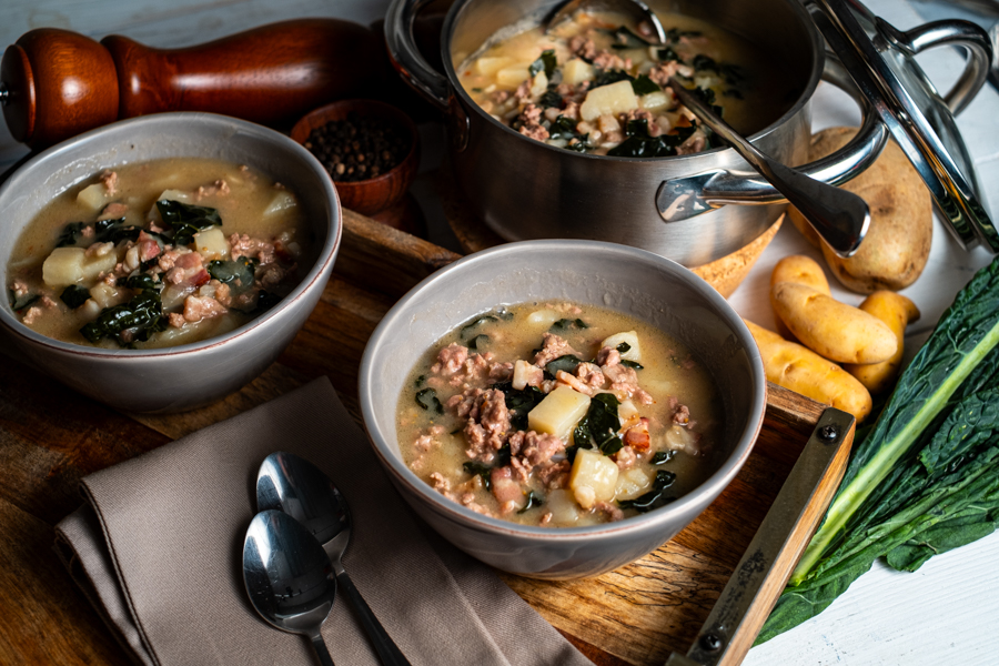 Beautiful display of Autumnal soup and ingredients on a wood cutting block.