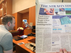 COVID temperature taking and Singapore news about masks